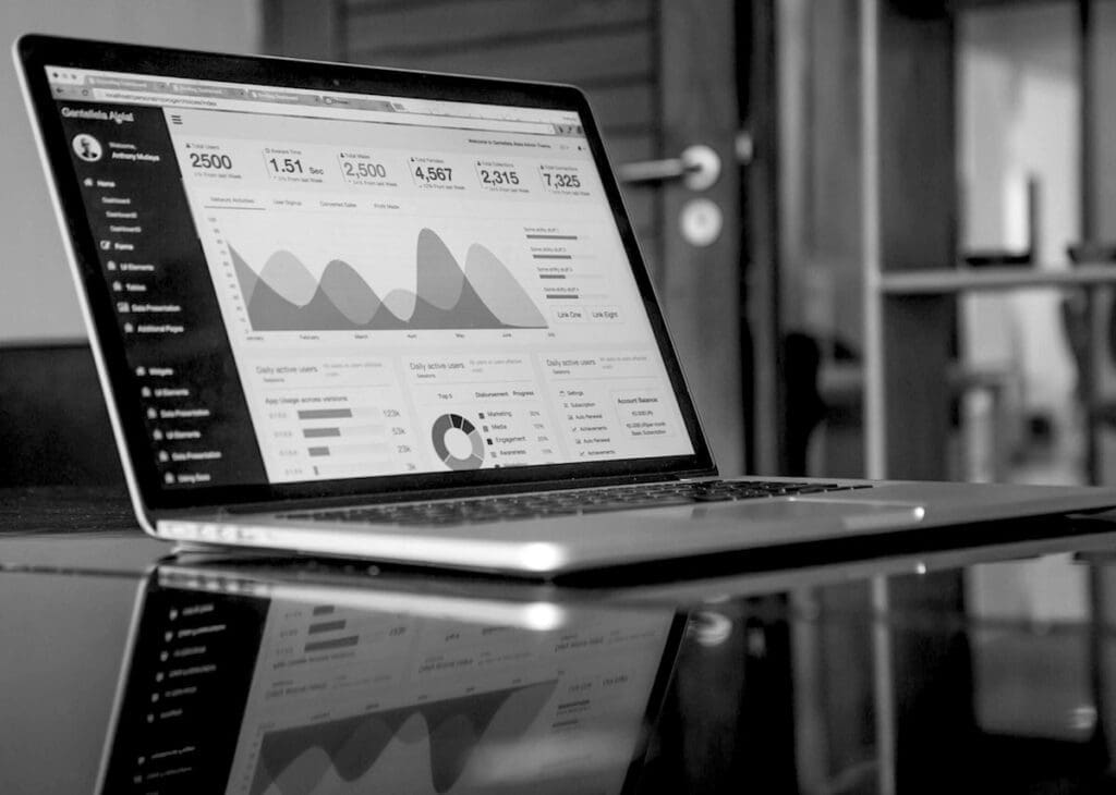 A laptop with analytics and marketing reports on the screen